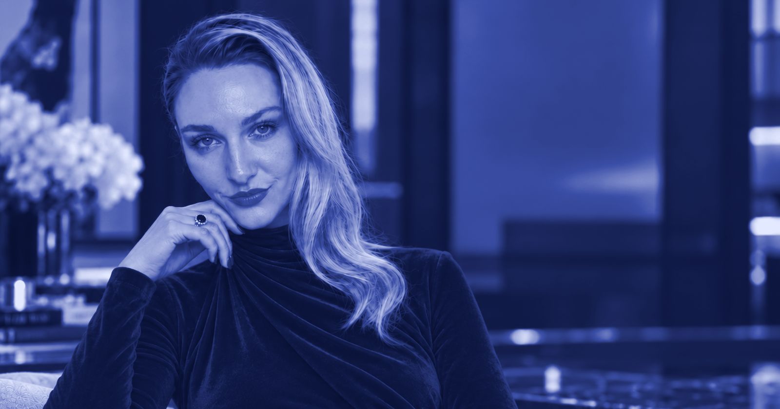 Margo seated in a lounge, shown in blue tones